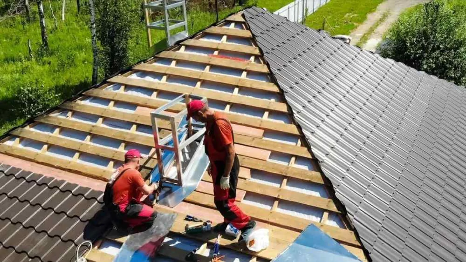 a couple of men working on a roof