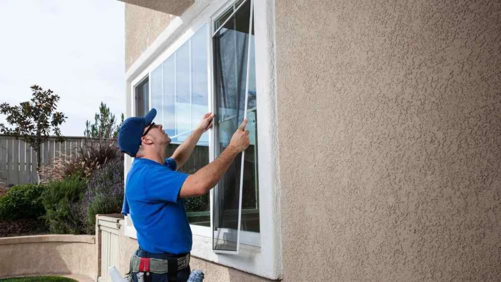 a man holding a glass door