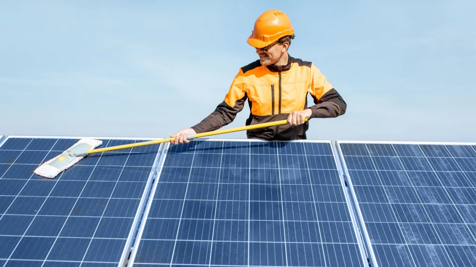 a man in a hard hat on a solar panel