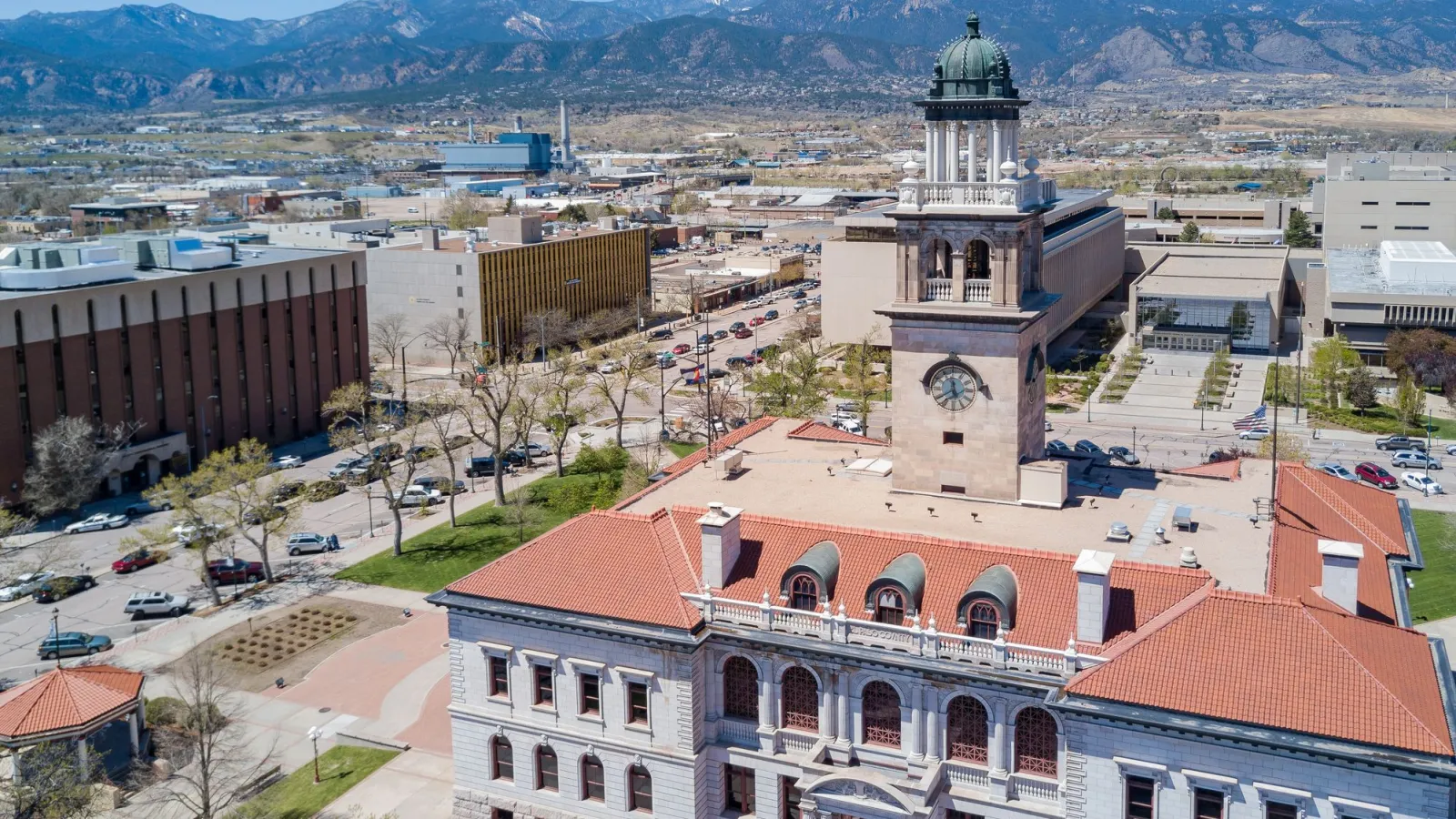 a large building with a mountain in the background