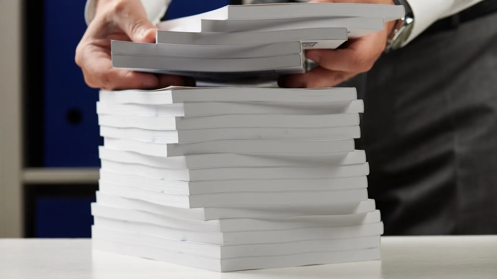 A man with a stack of Perfect Bound Books
