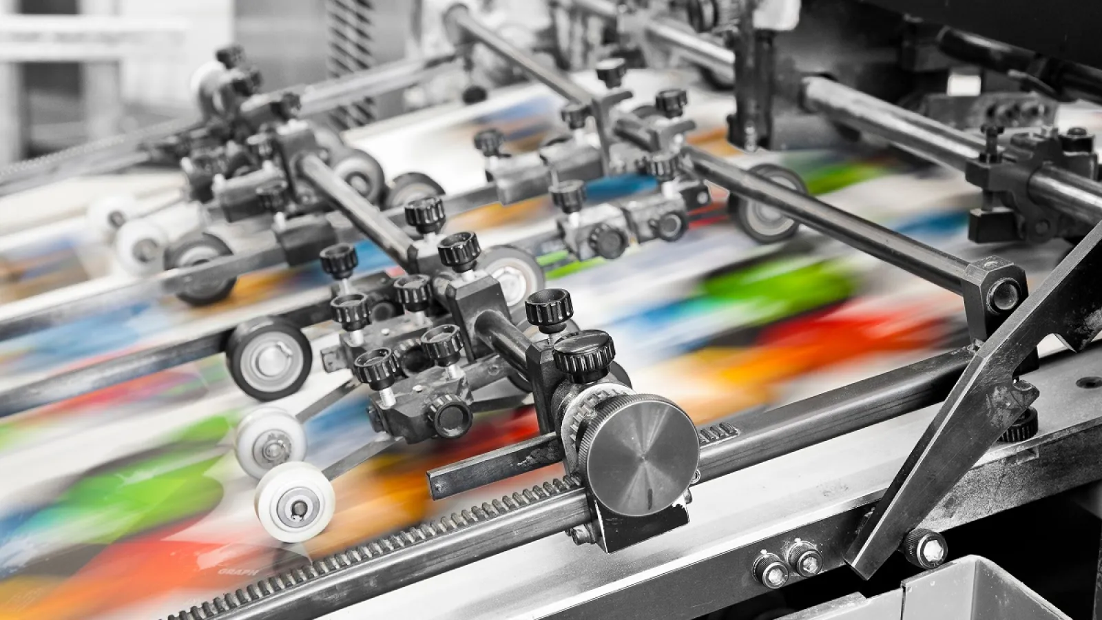 Paper moving through an Offset Printing Press