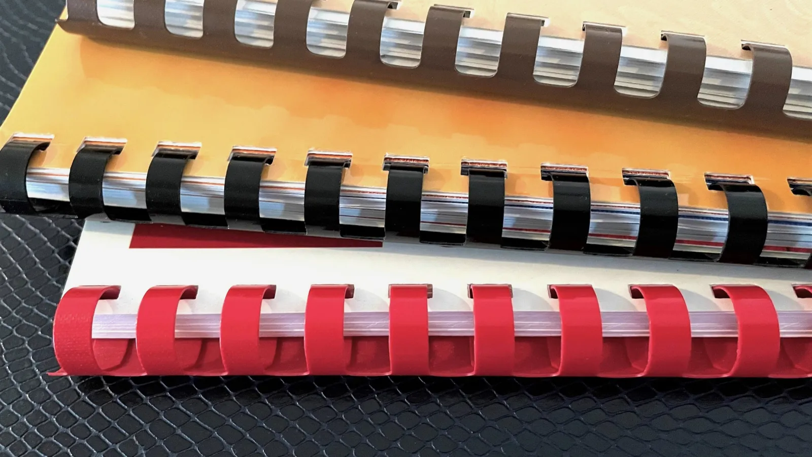 A stack of Comb Bound Books