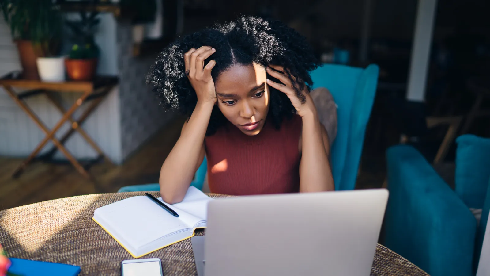 a woman sitting at a table with a laptop