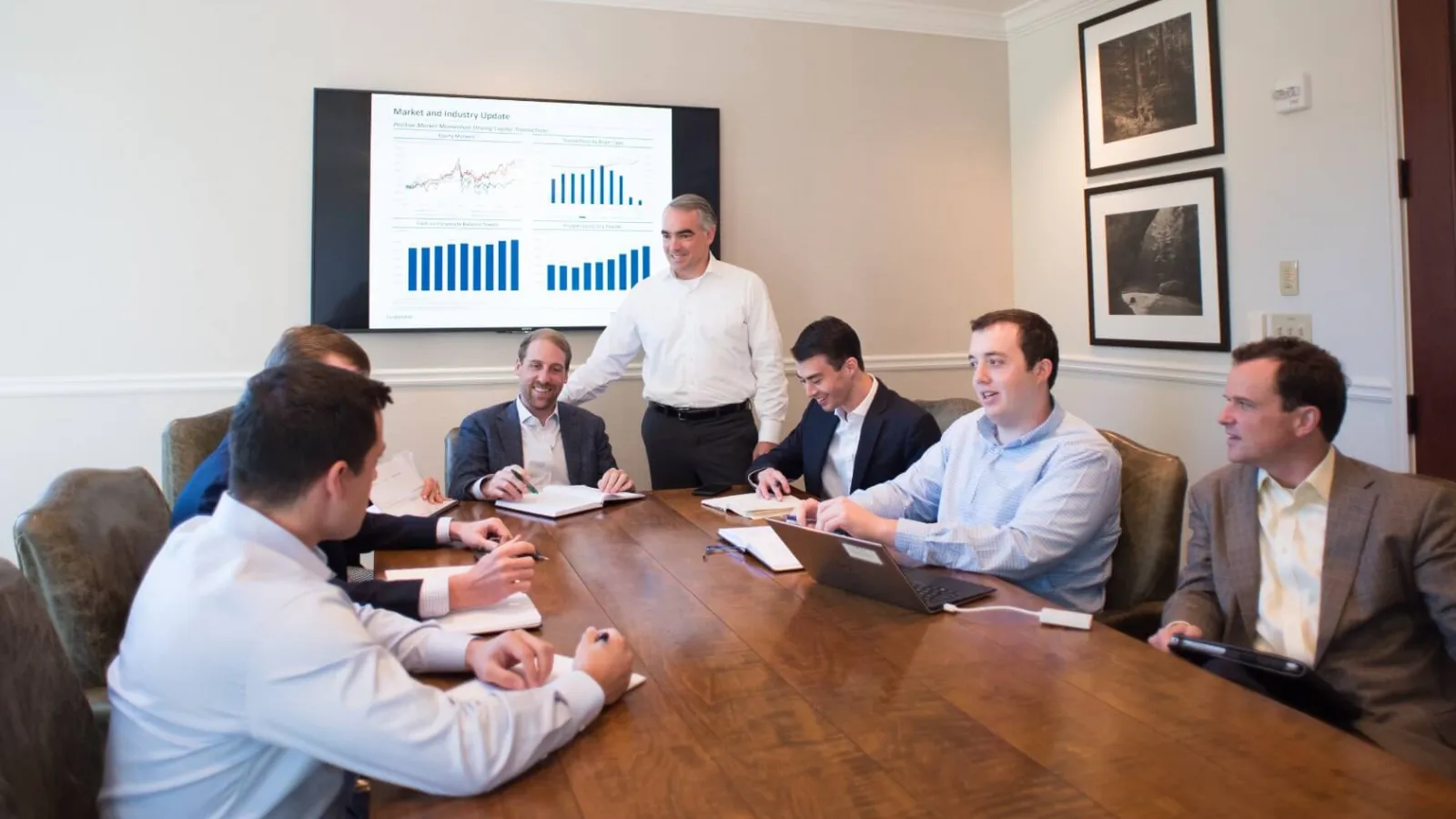 group of men sitting around a presentation