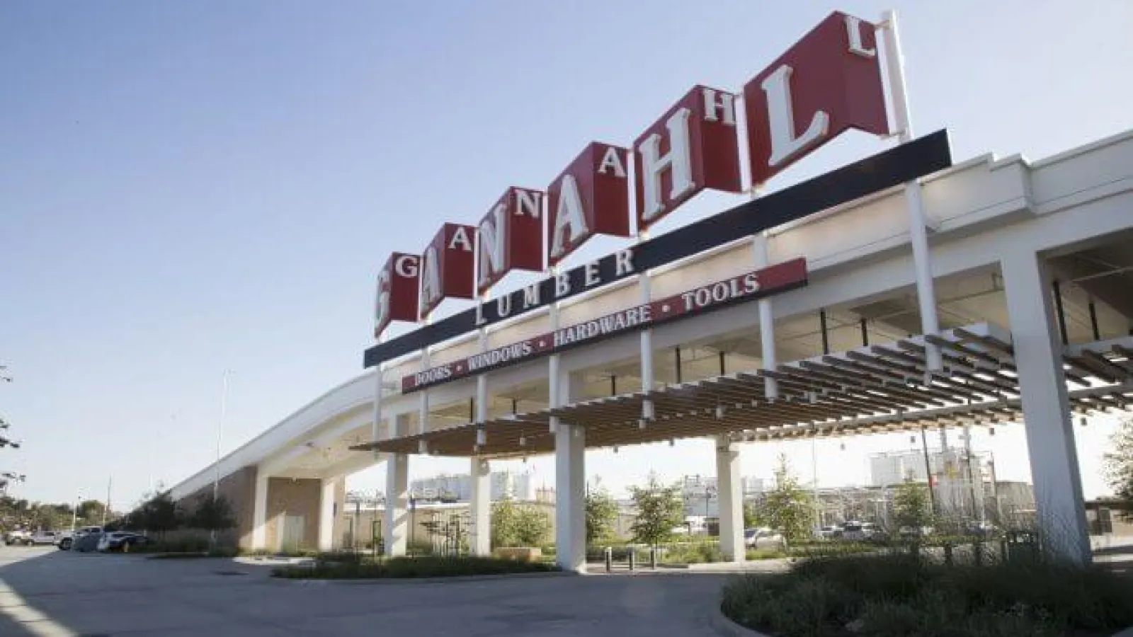 Exterior view of Ganahl Lumber store with large signage and canopy over entrance on a sunny day