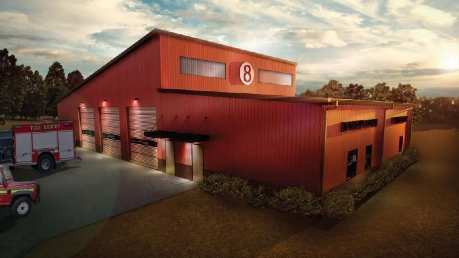 Red fire rescue station with multiple garage doors and parked fire trucks at sunset under a partly cloudy sky