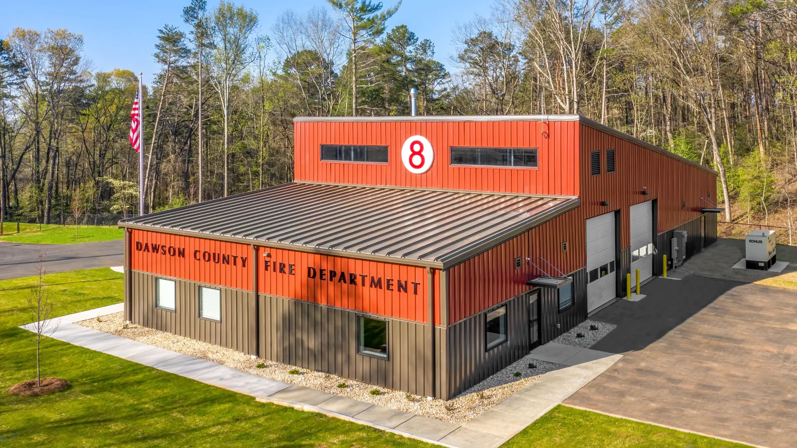 Modern Dawson County Fire Department building with red and brown exterior surrounded by green lawn and trees