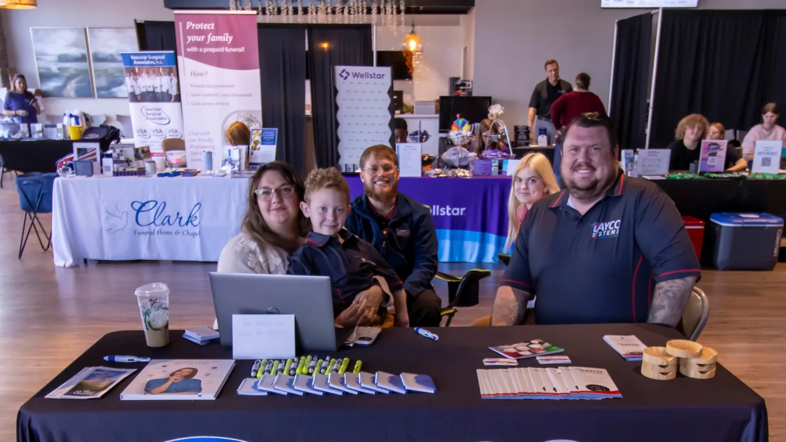 Dayco Systems team at a promotional event showcasing heating, cooling, and plumbing services.