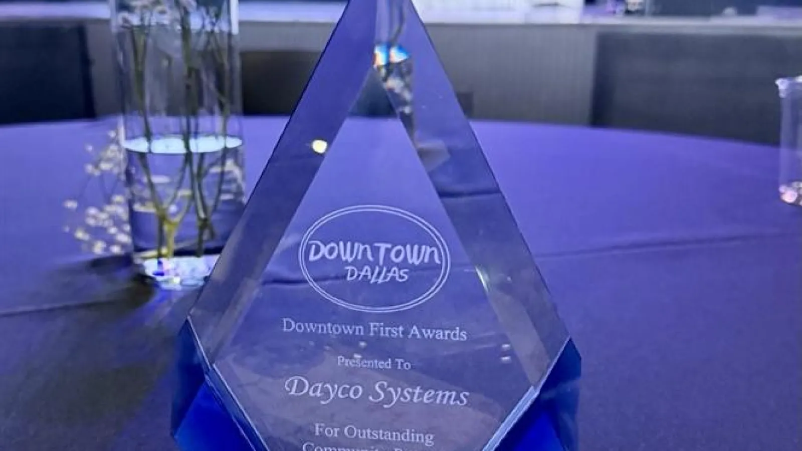 Crystal award on a table recognizing Dayco Systems as an Outstanding Community Partner in Downtown Dallas 2026.