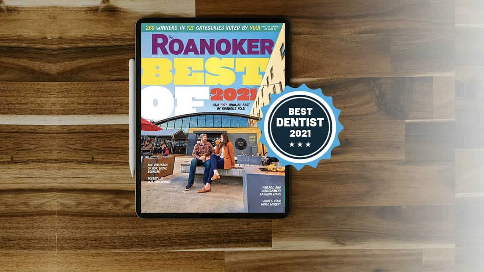 Tablet displaying Roanoker Best of 2021 magazine cover with Best Dentist 2021 badge on wooden table.