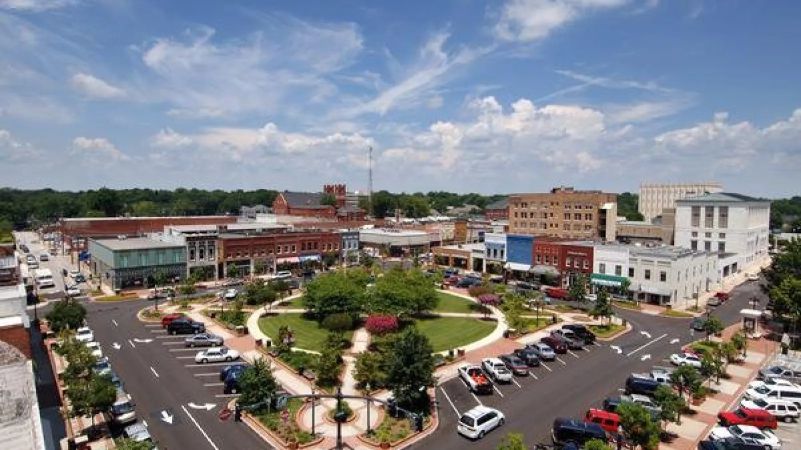 a parking lot with cars and buildings