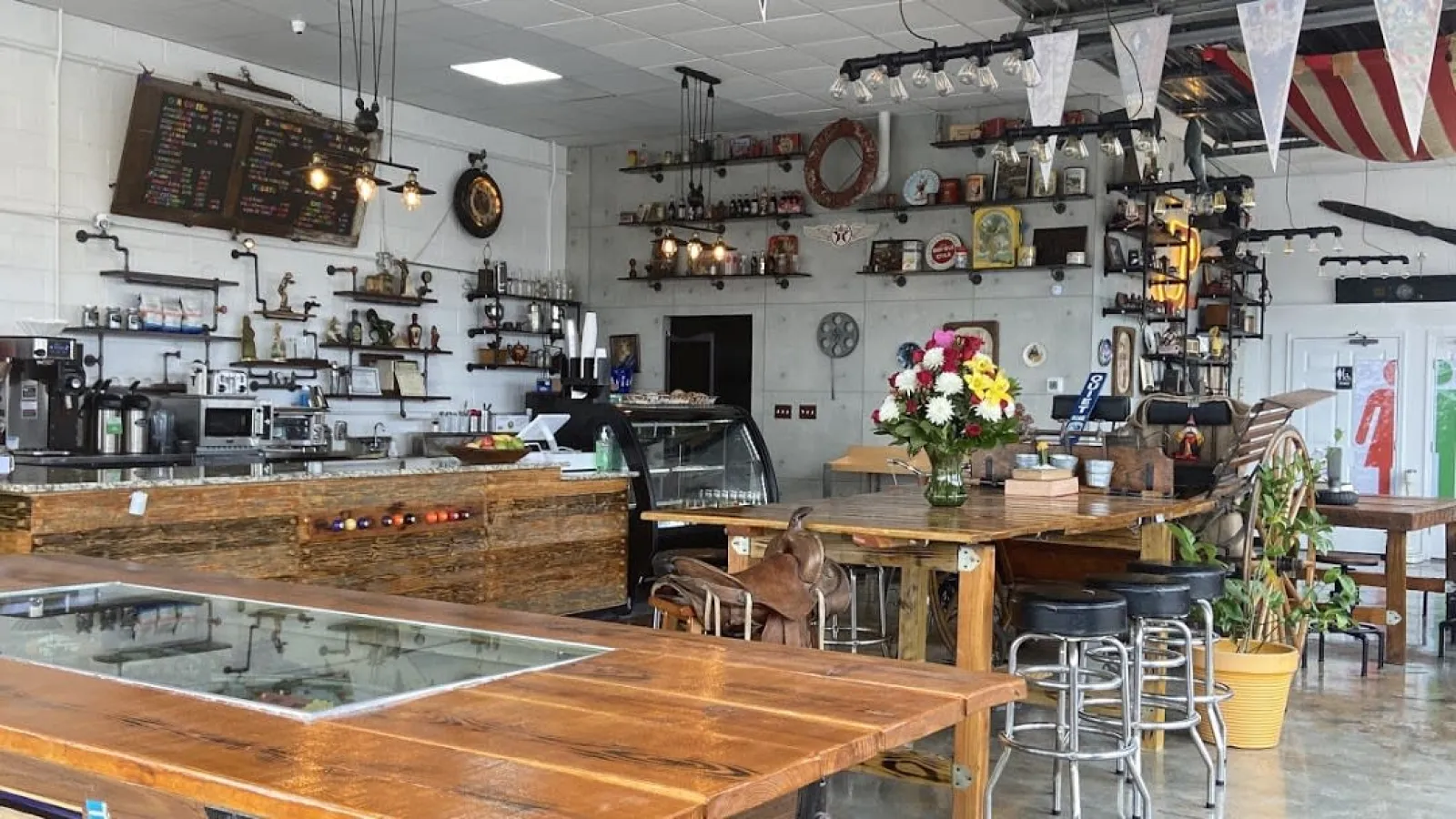 a bar with stools and tables