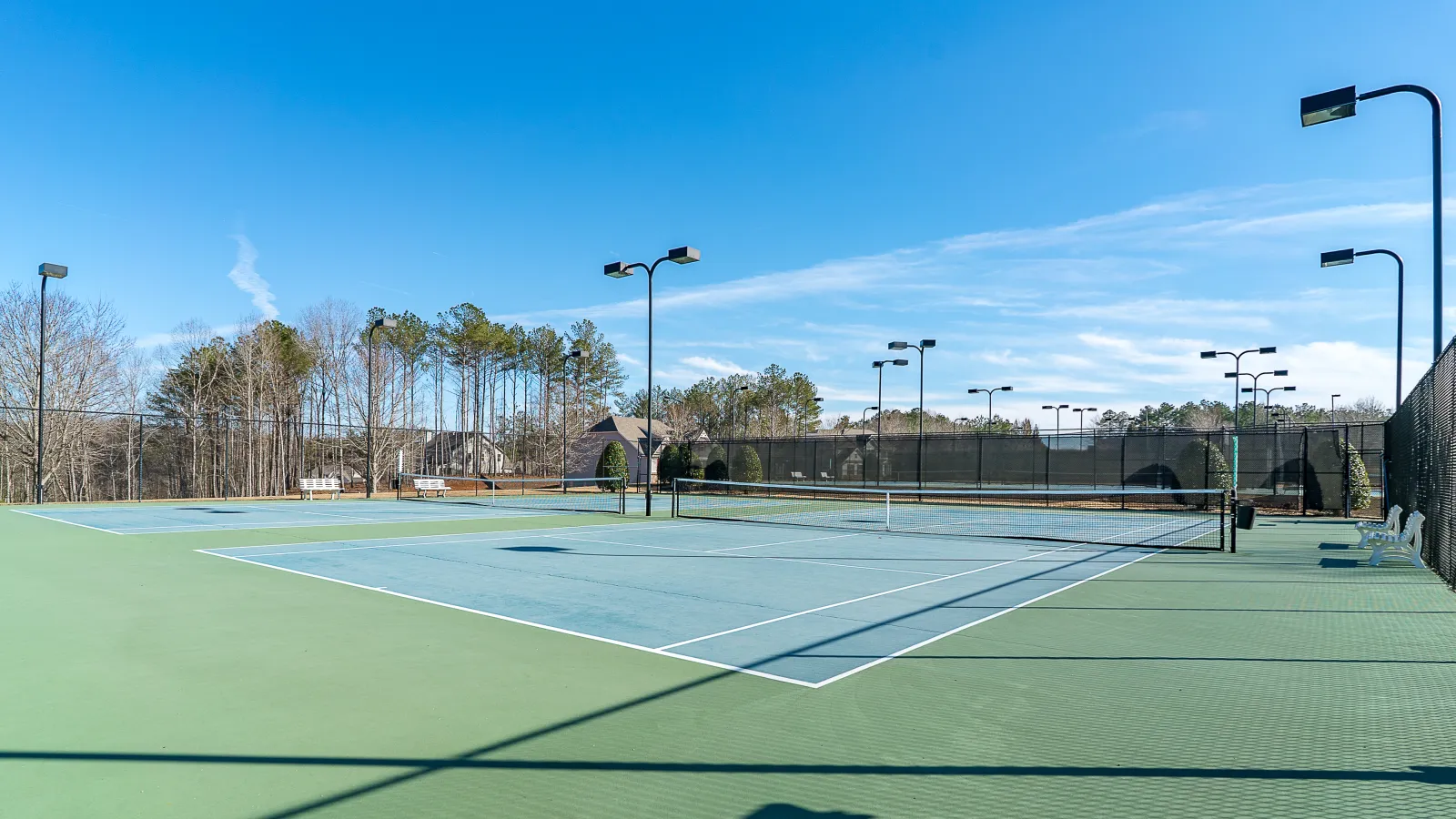 a tennis court with trees in the background