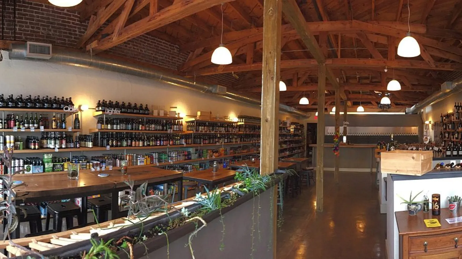 a large room with many tables and shelves with bottles of alcohol