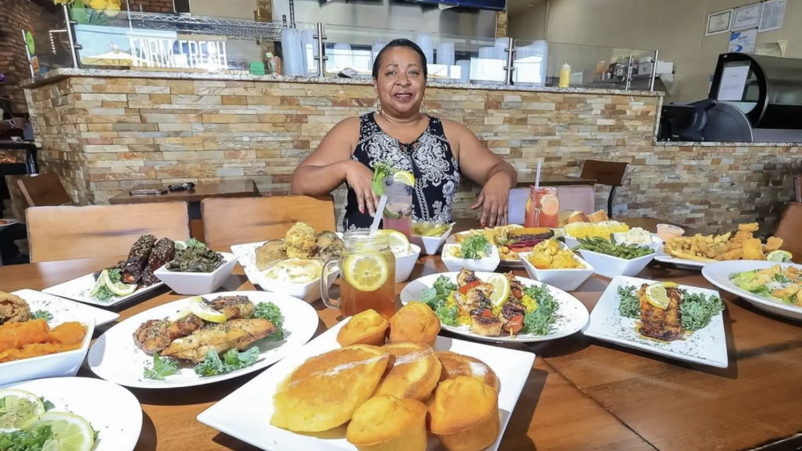 a person sitting at a table full of food