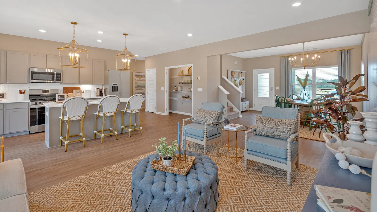 Modern open-concept living space featuring stylish furniture and warm lighting.