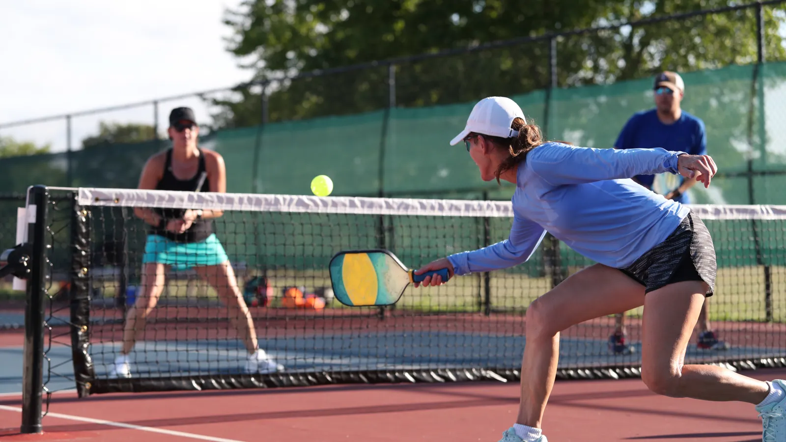 a woman hitting a ball with a tennis racket