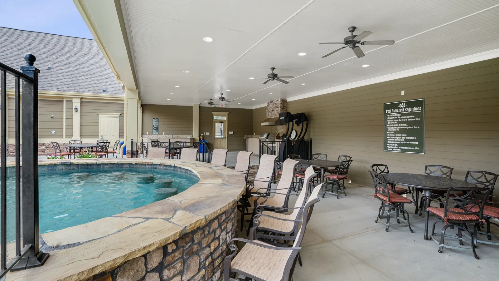 a swimming pool with chairs around it