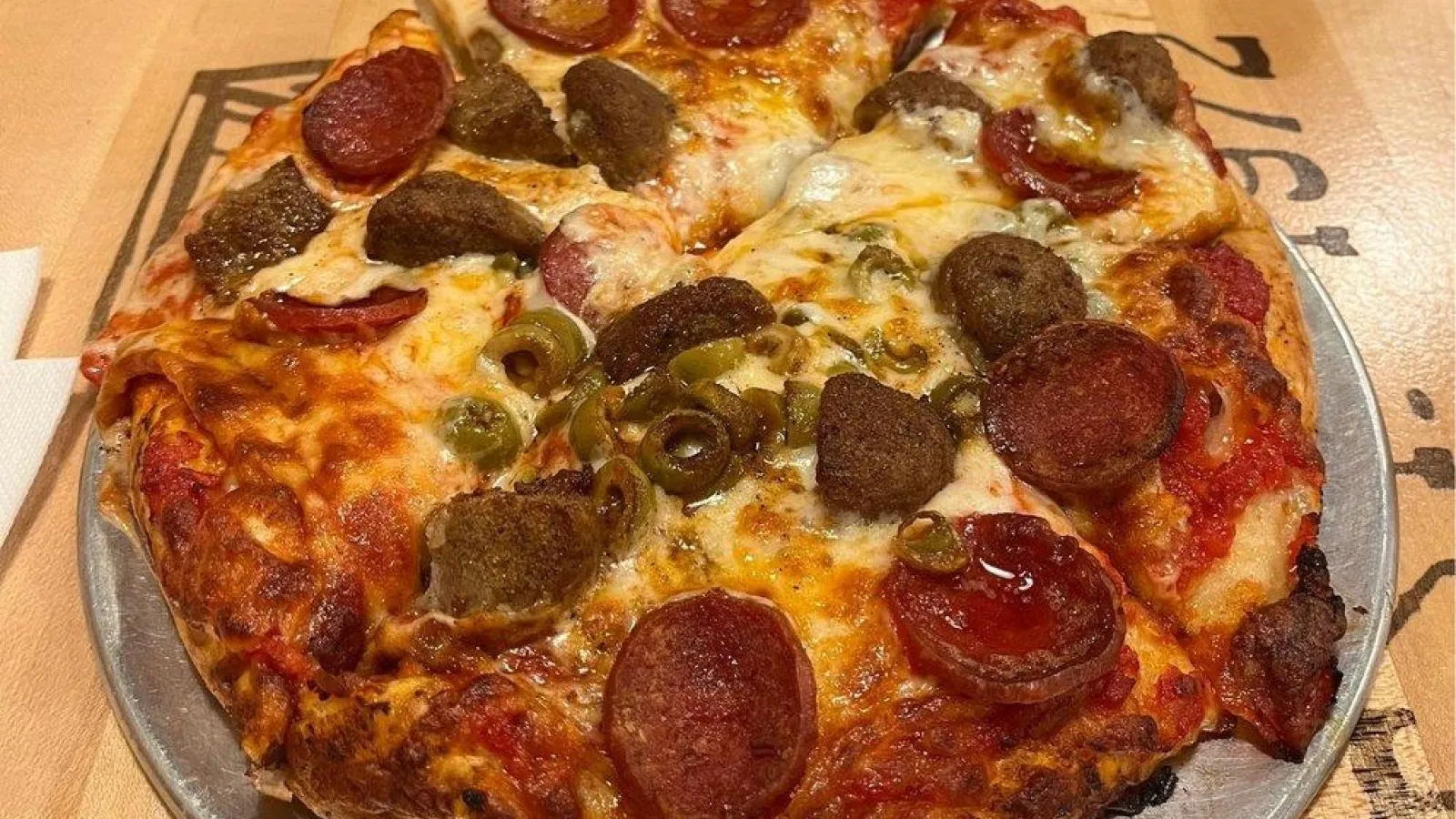 a pizza with pepperoni and olives