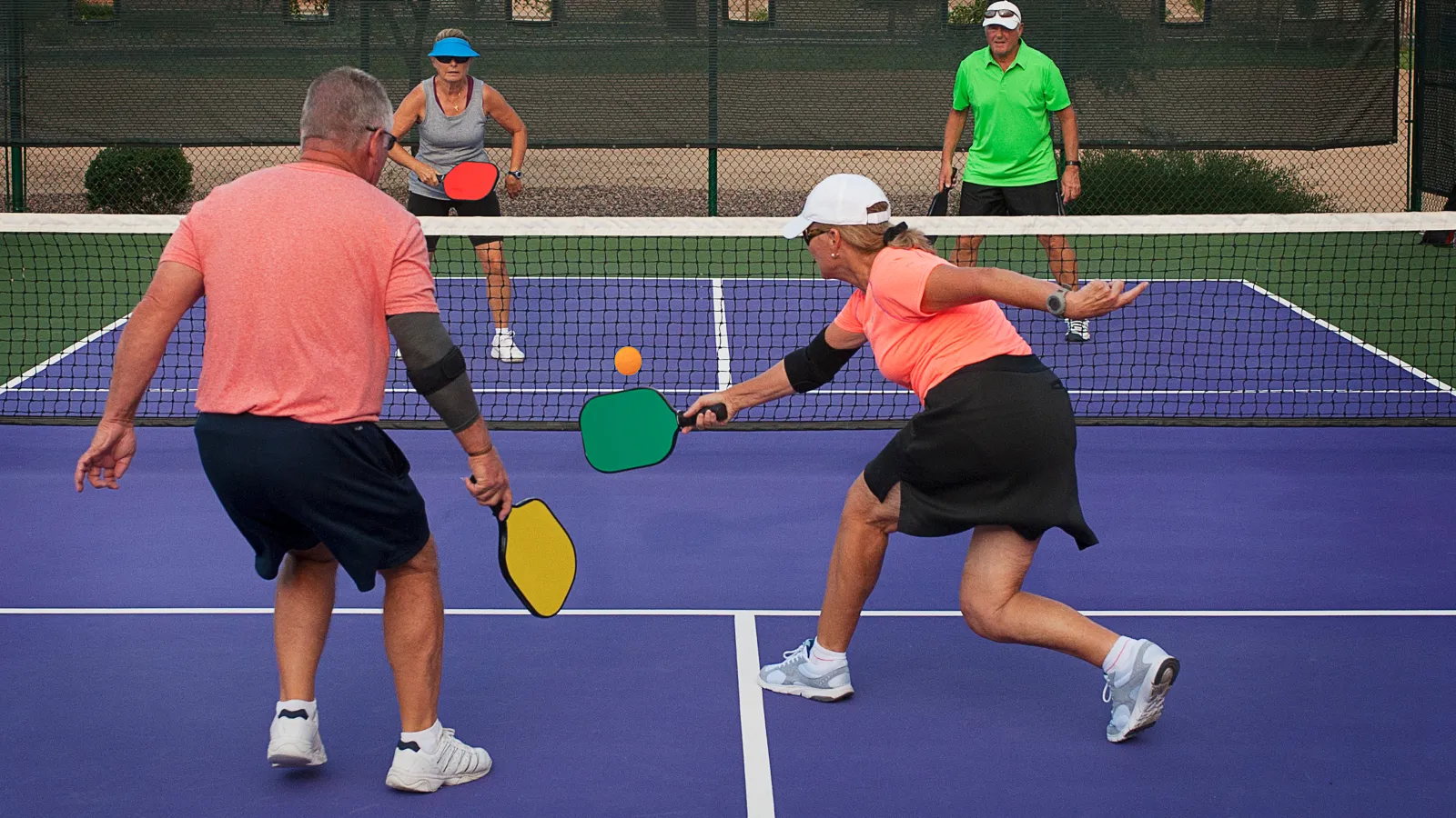 a couple of people play tennis