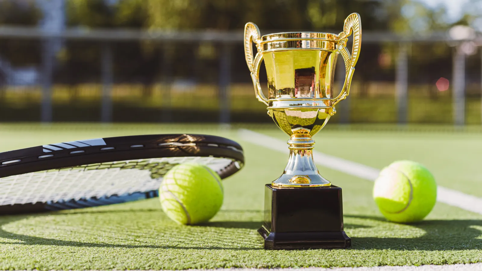 a trophy and balls on a golf course