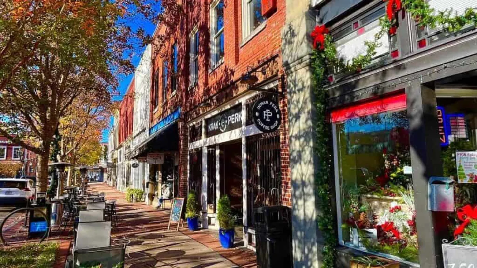 a sidewalk with a brick building and a clock on it