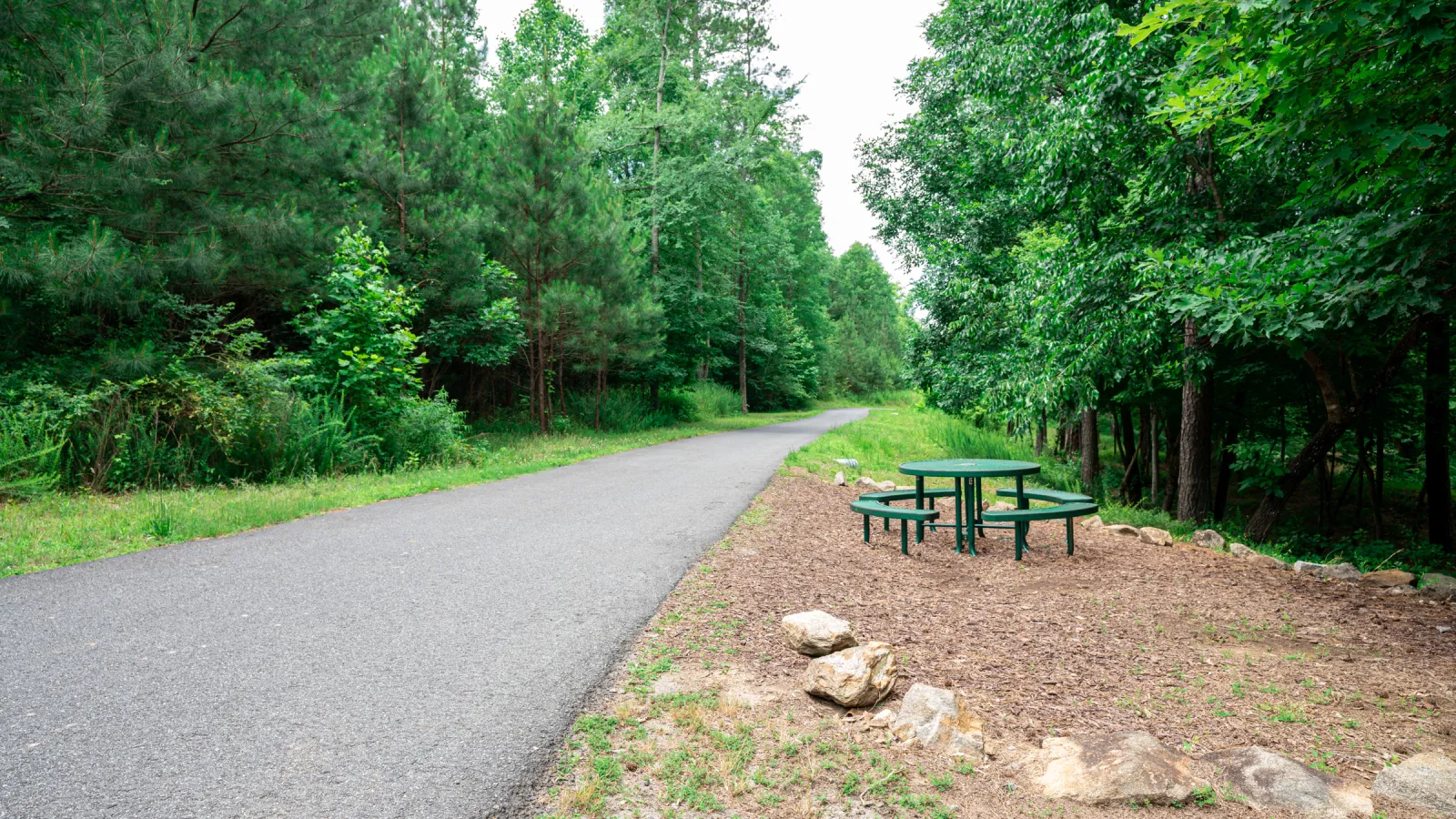 a picnic table sits on the side of a road