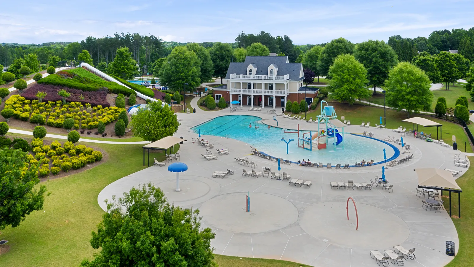 a large house with a pool and trees around it