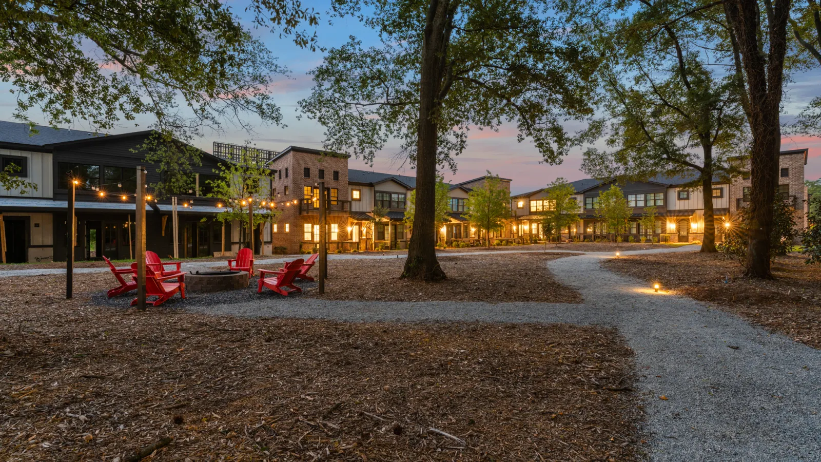 a group of red chairs in a park