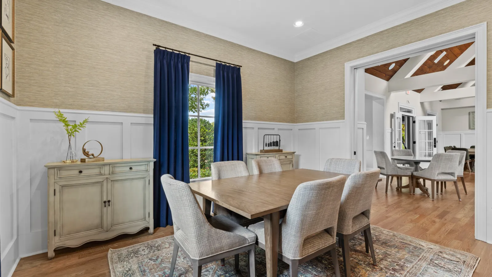 a dining room with a table and chairs