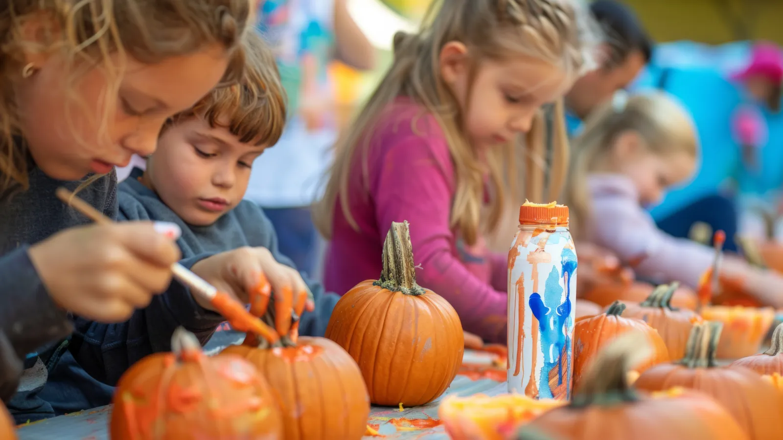 a group of children carving pumpkins