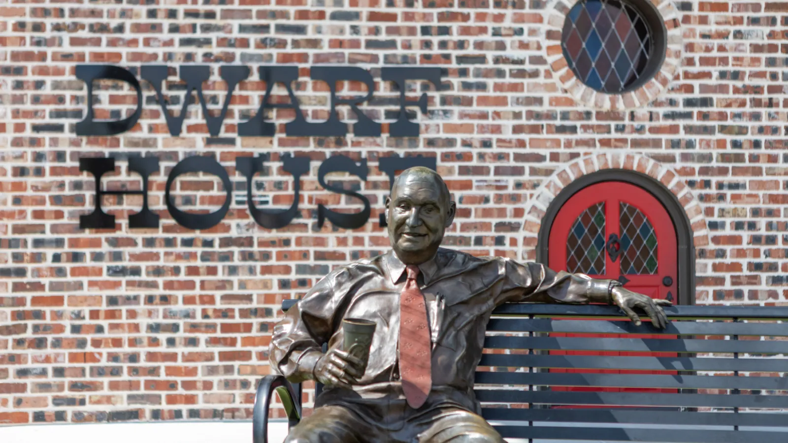 a statue of a man sitting on a bench