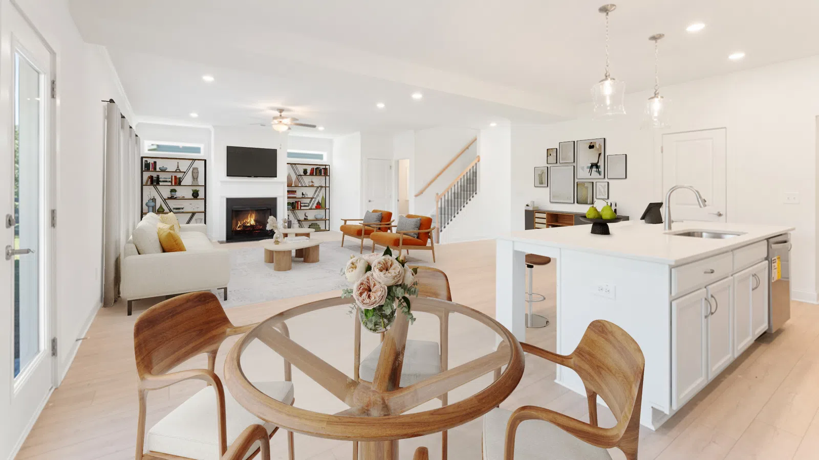 Bright modern open-concept kitchen and living area with wooden chairs, white island, and cozy fireplace.