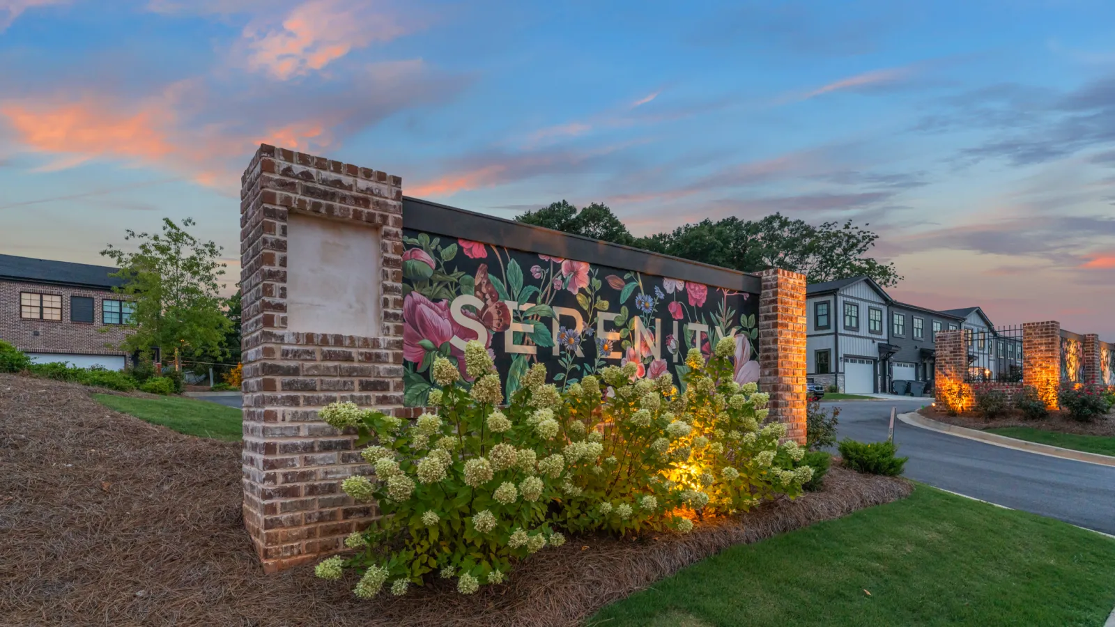 a wall with flowers and a sign