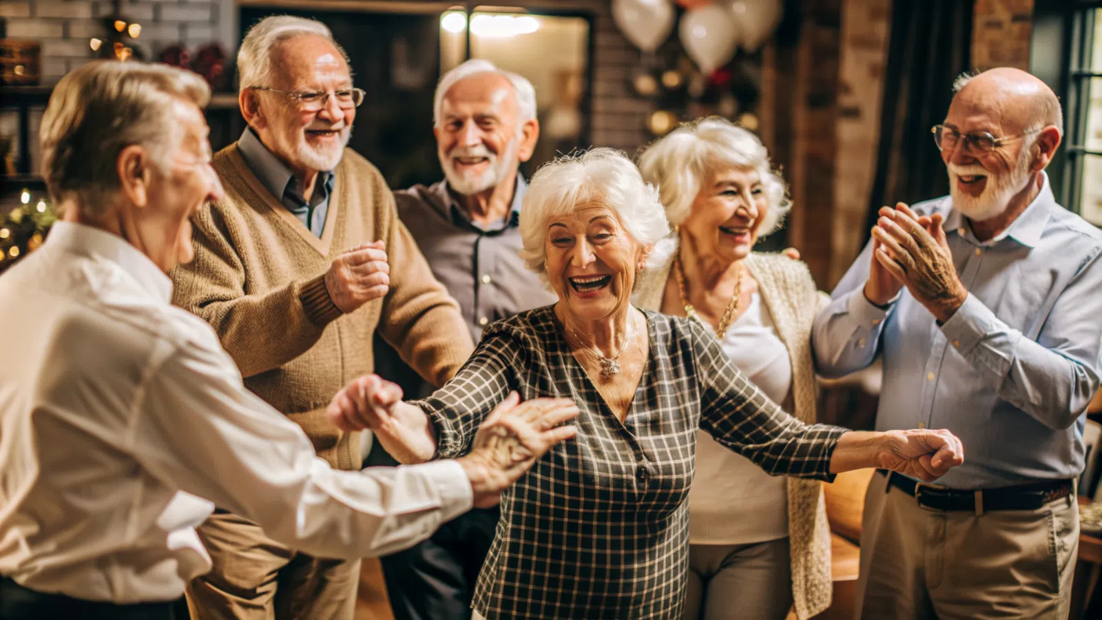 Happy senior friends dancing and enjoying a lively gathering indoors with smiles and laughter