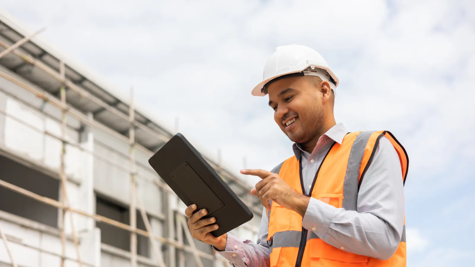 a person in a hard hat holding a tablet