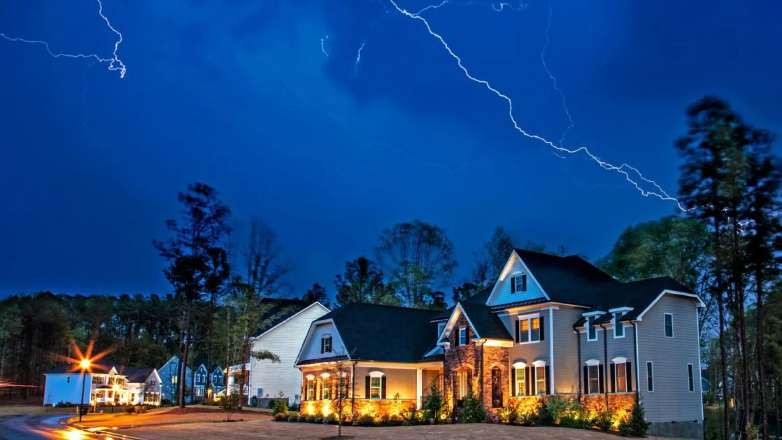 a house with lightning striking the ground. Storm Damage.
