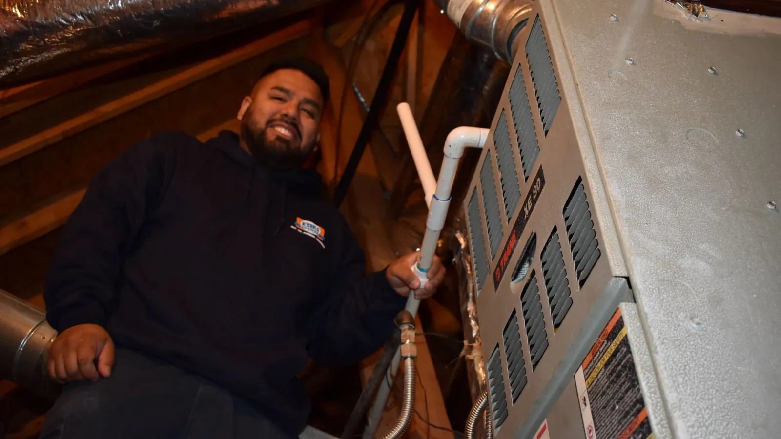 Estes Technicians fixing a furnace in the attic