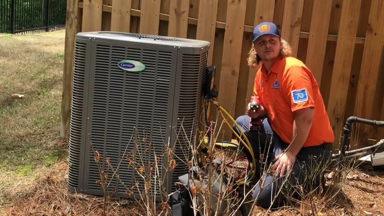 Estes Services Technician fixing an Air Conditioner in Atlanta