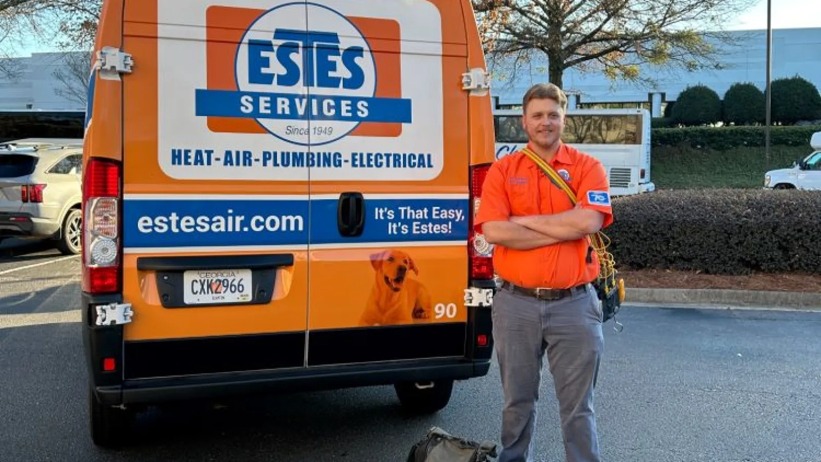 Estes Services HVAC Tech in front of a Estes Van