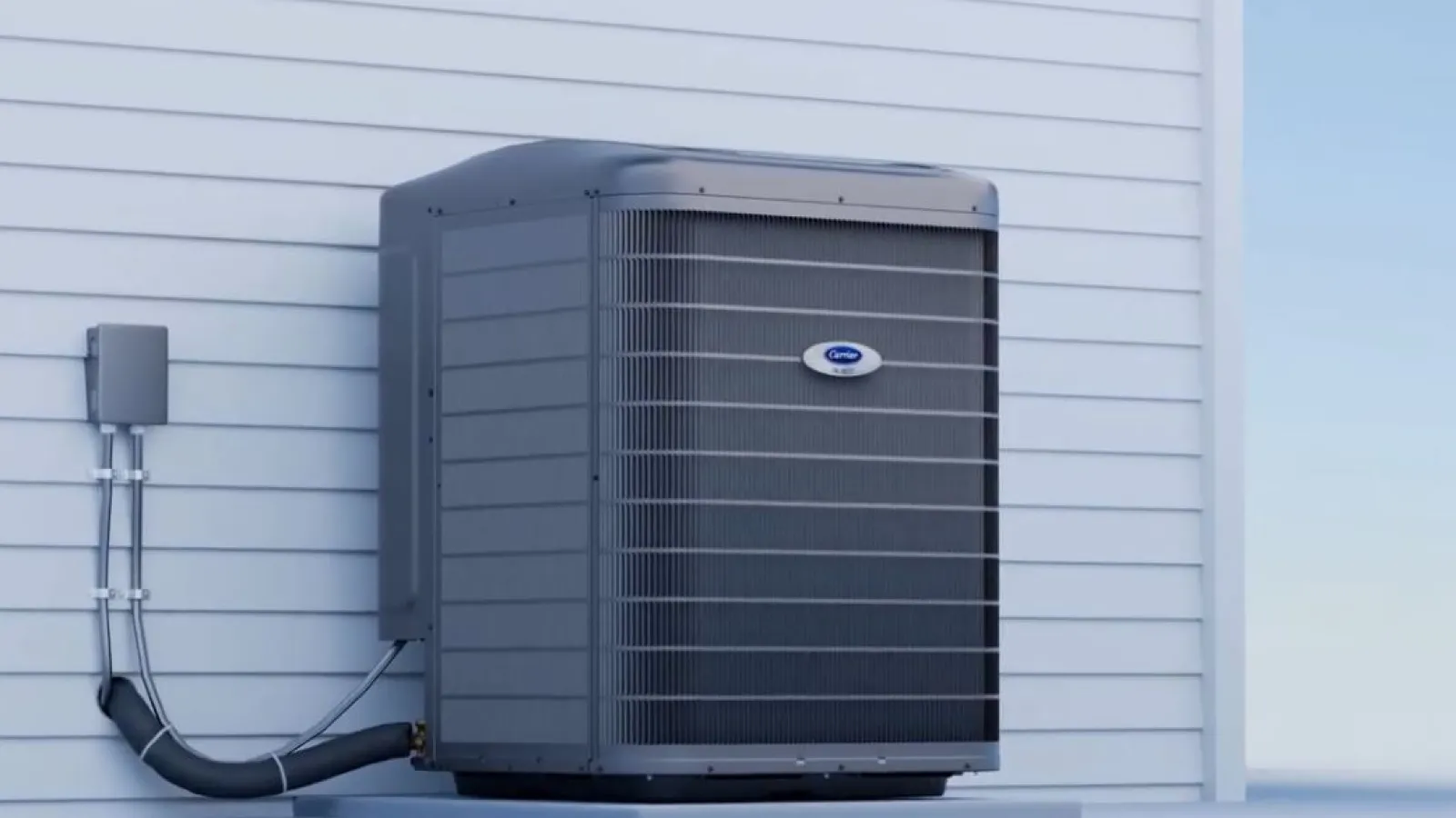 Outdoor Heat Pump unit installed on a concrete platform against white siding wall under clear sky.