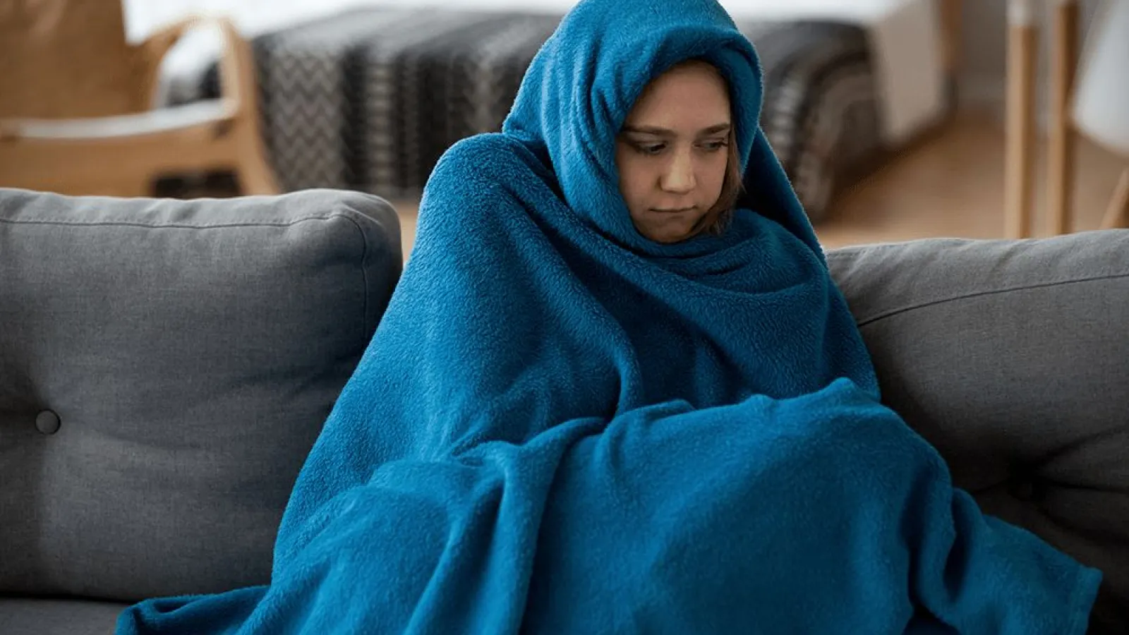 a person wrapped in a blue blanket