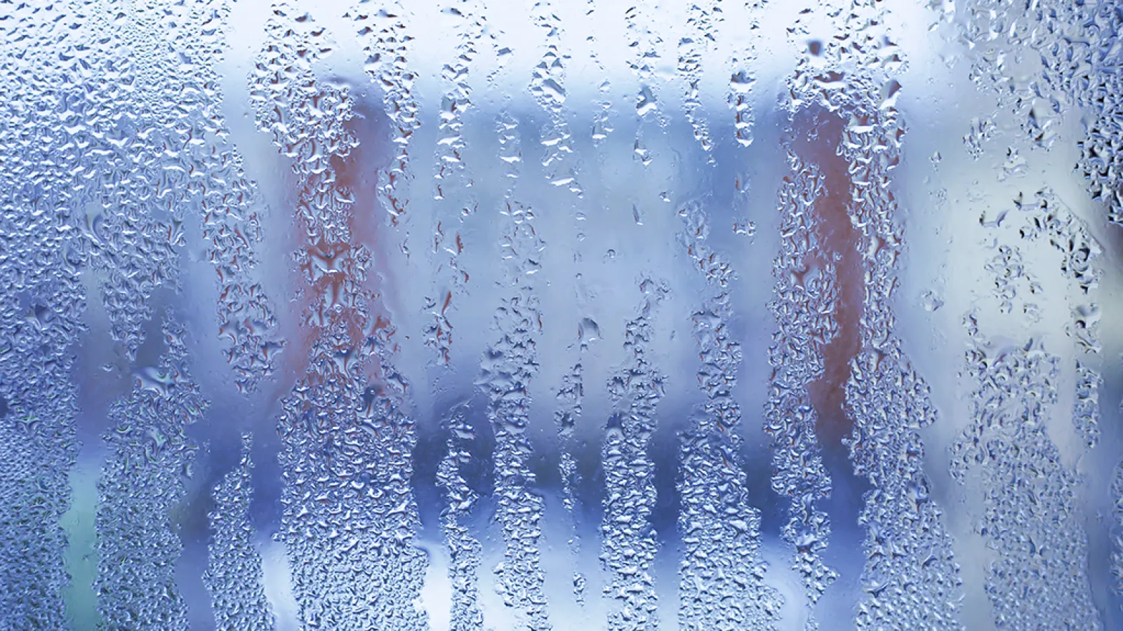 a window covered in rain. Humidity Level in winter