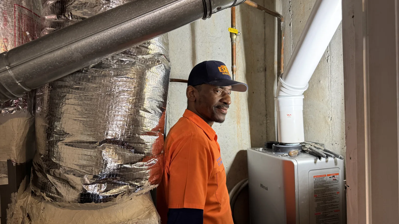 Estes Plumber installing a tank less water heater.