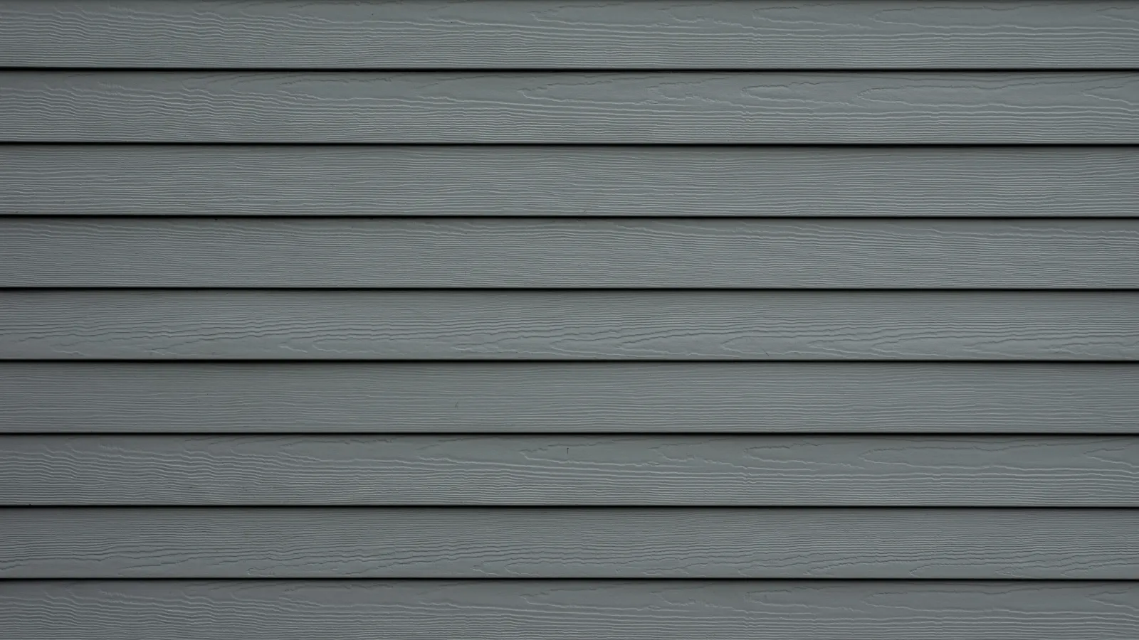 Close-up of dark gray horizontal wooden siding with textured grain finish on exterior wall.