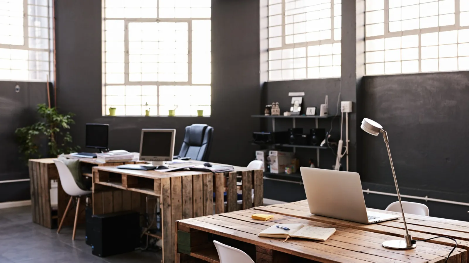 a room with a desk and computers