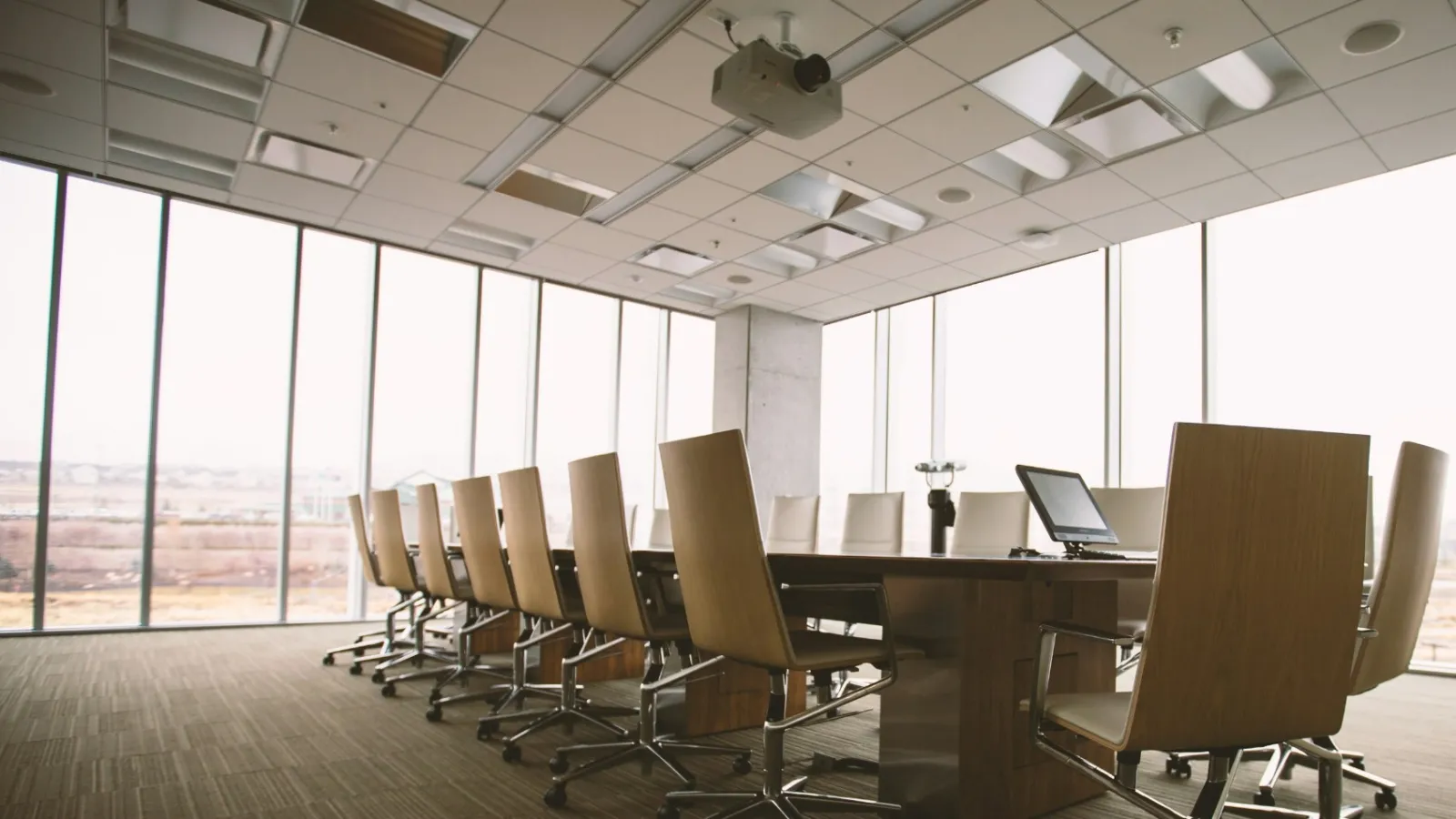 a room with a desk and chairs