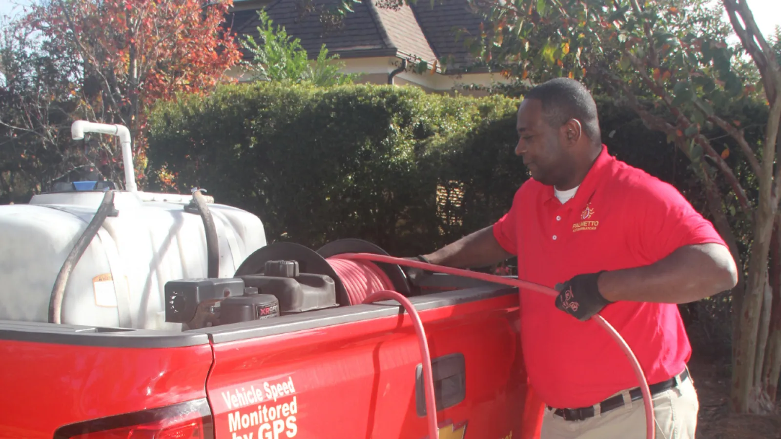 a man standing next to a red truck