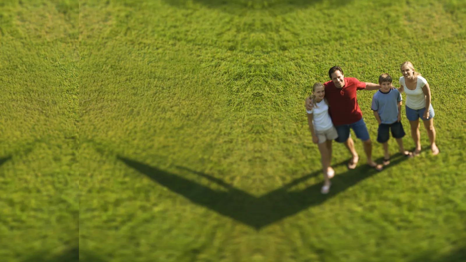 a group of people walking on a grassy field